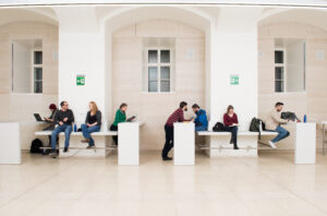 Students in the hallways of the University of Vienna studying and reading