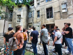 Picture of students standing in front of a socialist housing stock in Belgrade