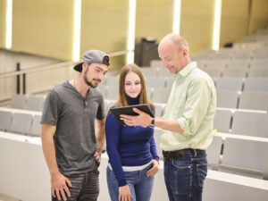 Picture of 2 students with a teacher