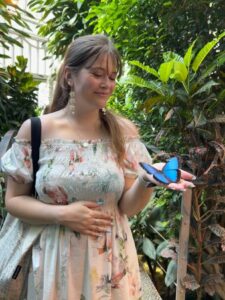 An image of Bridget in the Schmetterlinggarten (butterfly garden) in Vienna.